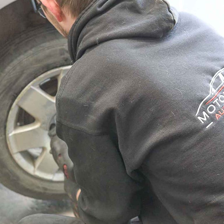 A Motorvation Northampton technician checking a tyre as part of an MOT